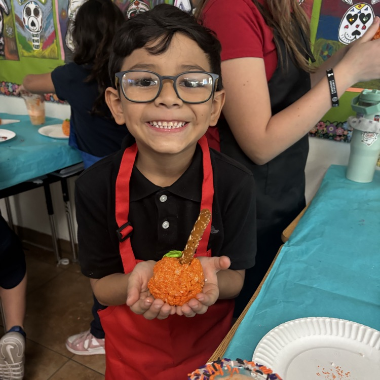 child with pumpkin treat