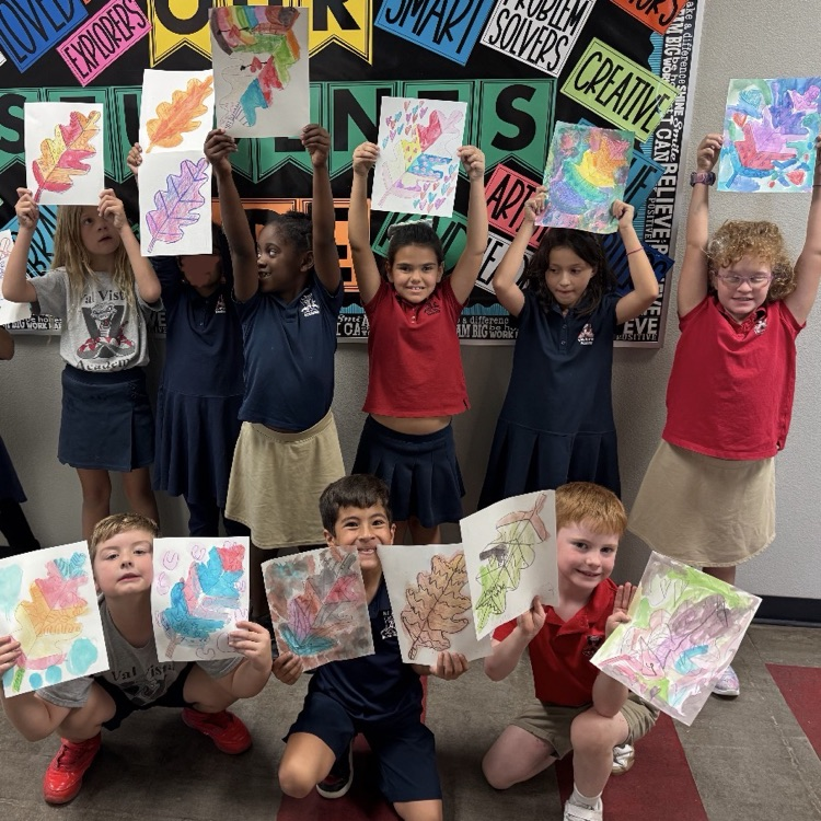 art club posing with drawings