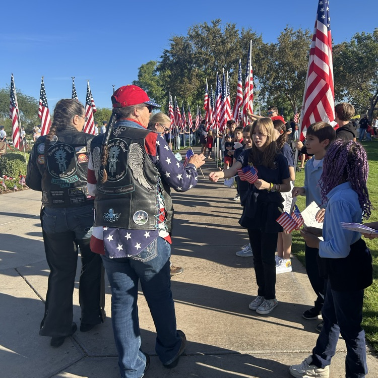 student handing out flag