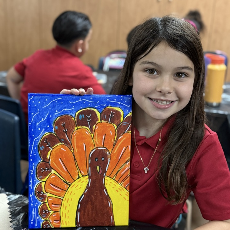 child smiling with painting