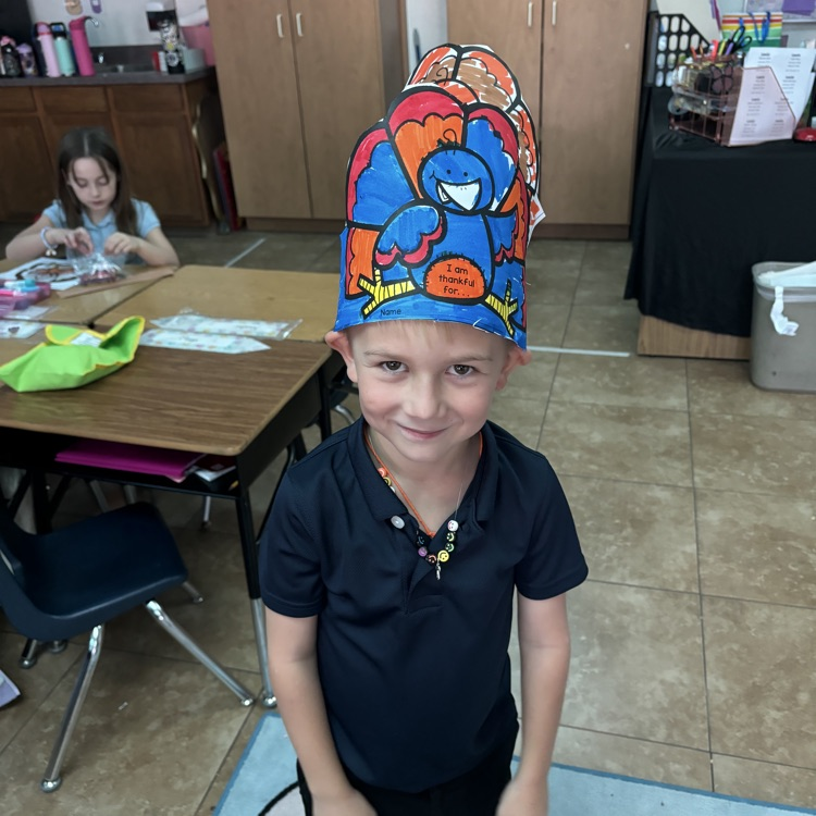 child in turkey hat