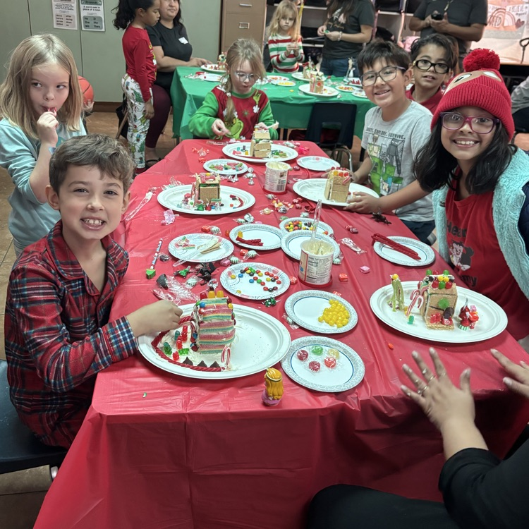 kids building gingerbread houses