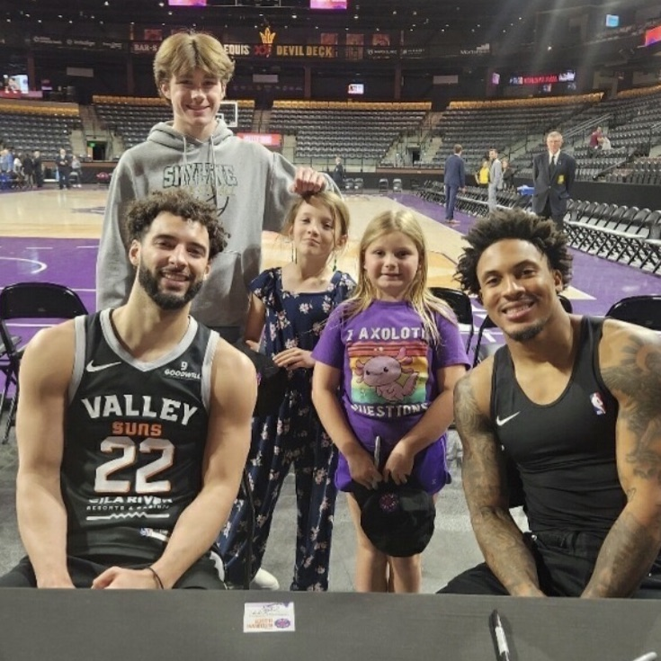 students with basketball players