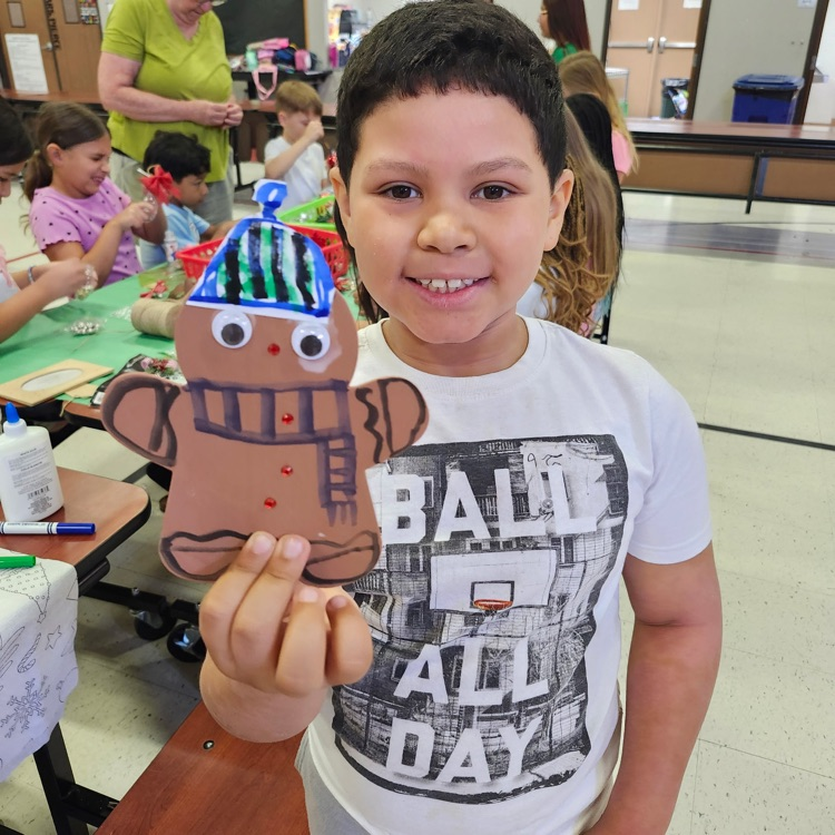 child with gingerbread craft