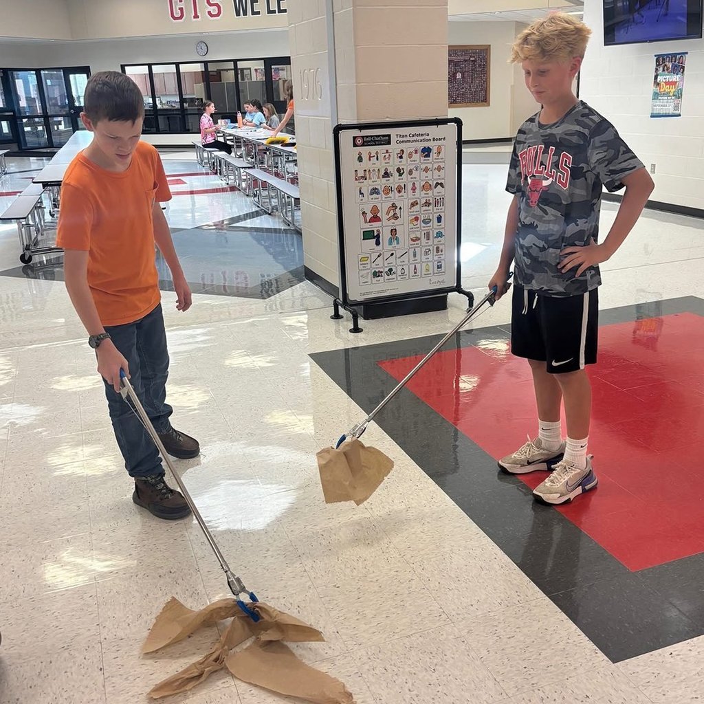 GIS leaders helping clean the cafeteria.