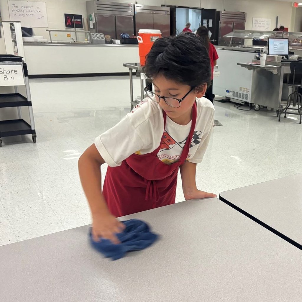 GIS leaders helping clean the cafeteria.
