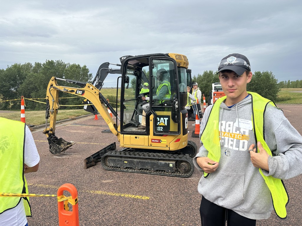 Tyler O. next to Construction Equipment
