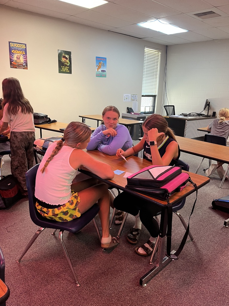 3 girls sitting around a table