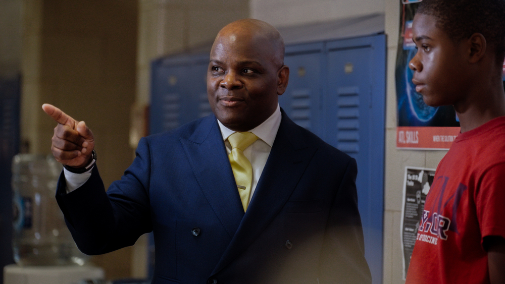 Dr. Dawson talking to a student in the school hallway