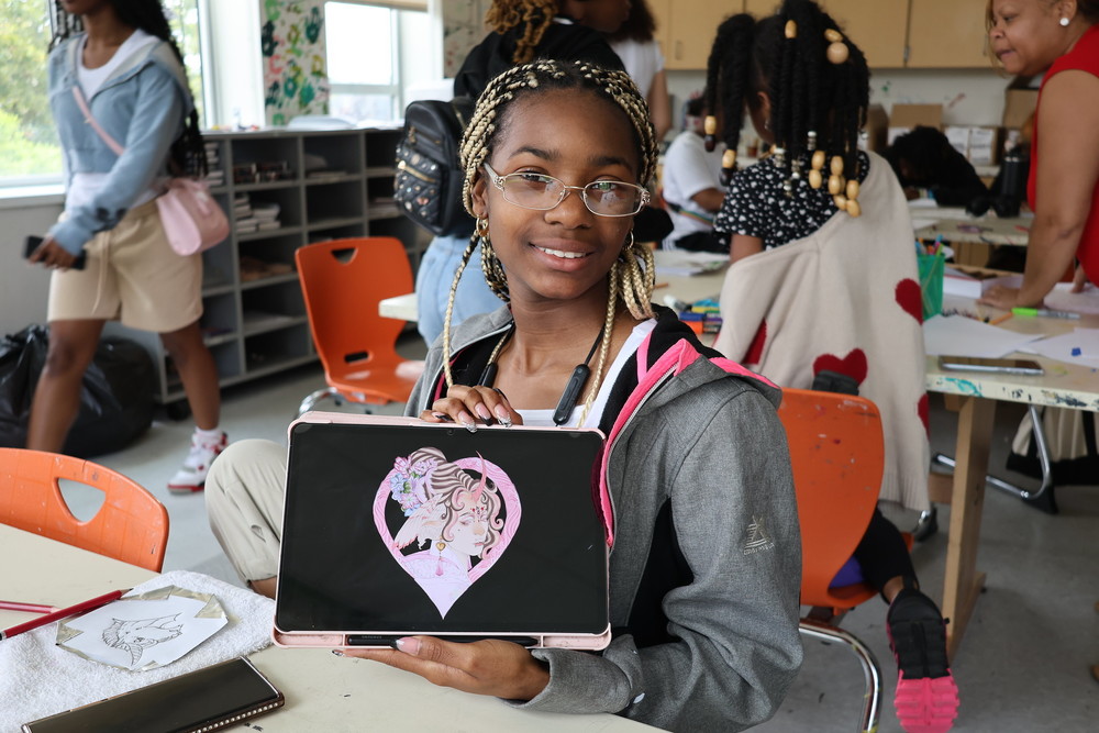 Amiyah poses with the graphic art created at Summer Camp.
