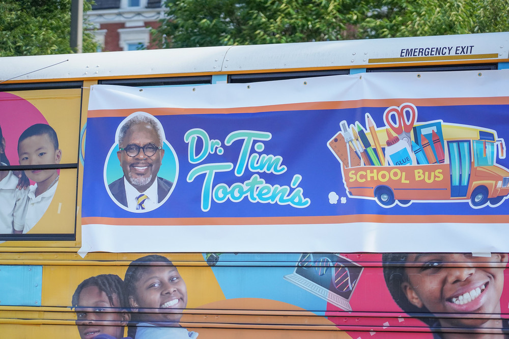 banner showing photo of Dr. Tim Tooten and school bus