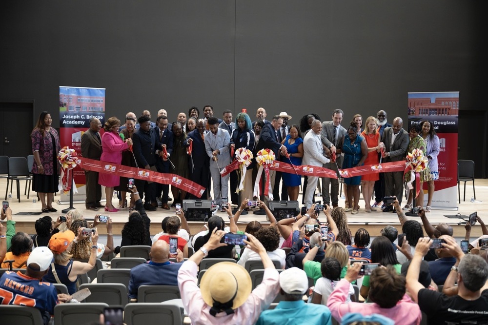 Students staff and families gather to cut the ribbon on the new renovations at Douglass