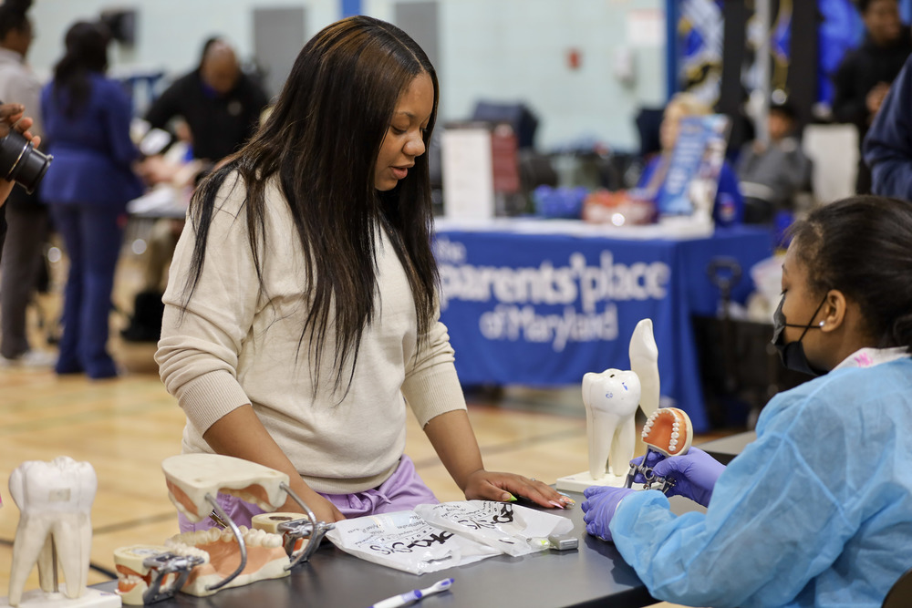 Student visiting a table at the school resource fair