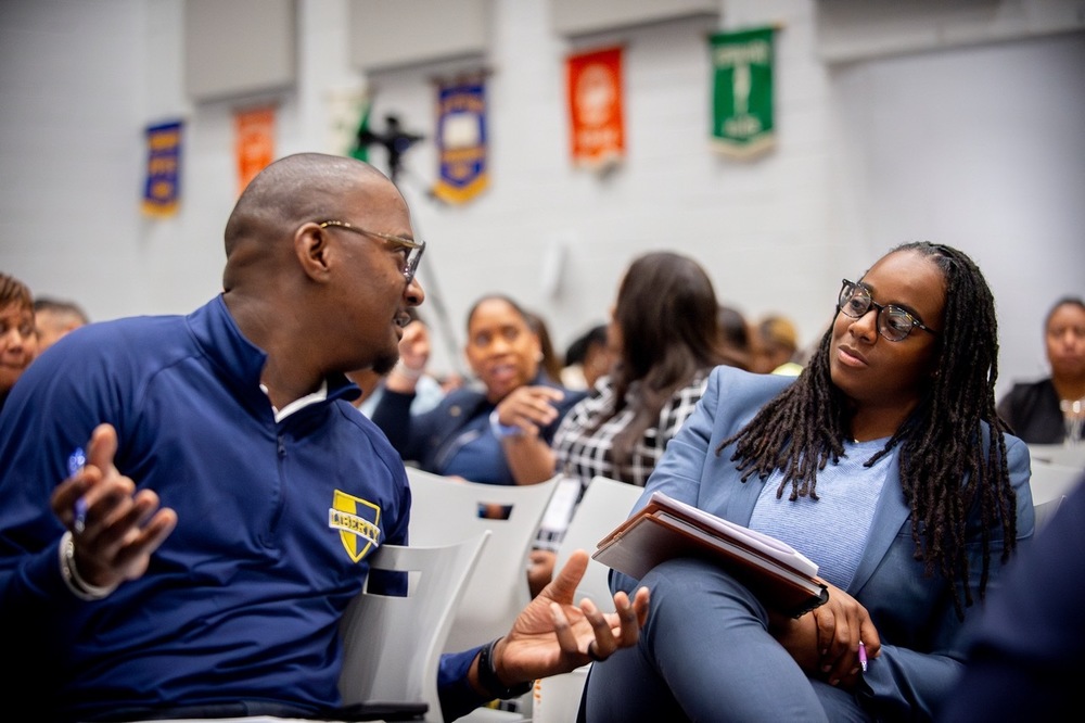 Two City Schools principal convene for a conversation during a professional development seminar. 