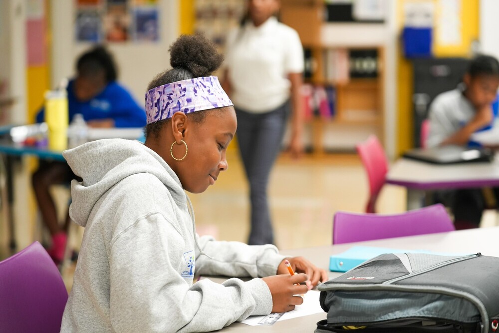City Schools student writing in class