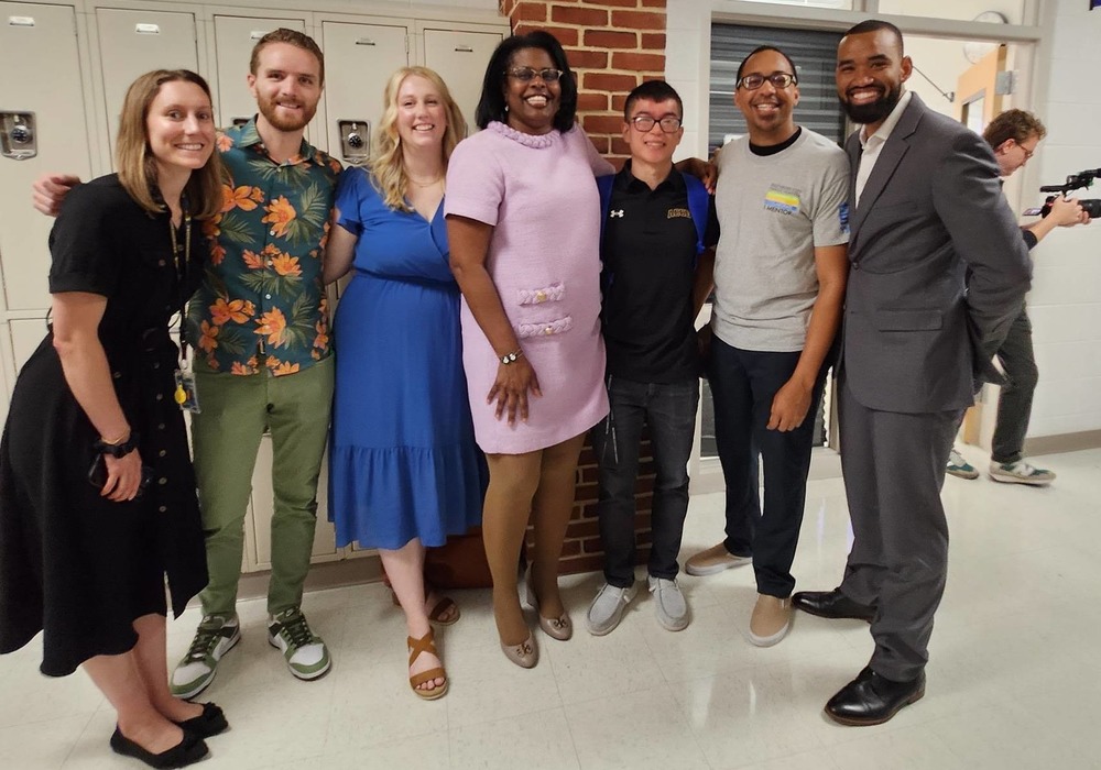 2026 TOY poses with CEO and other school staff member's to celebrate his win