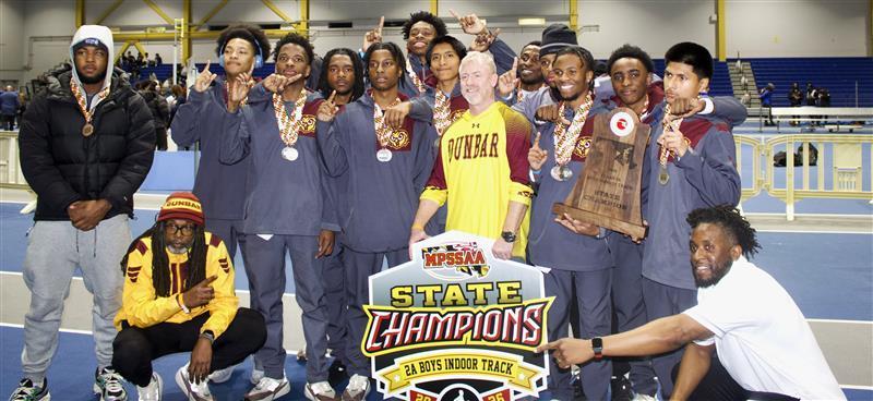 Paul Laurence Dunbar High School students holding the MPSSAA 2A Boys Indoor Track & Field State Championship sign