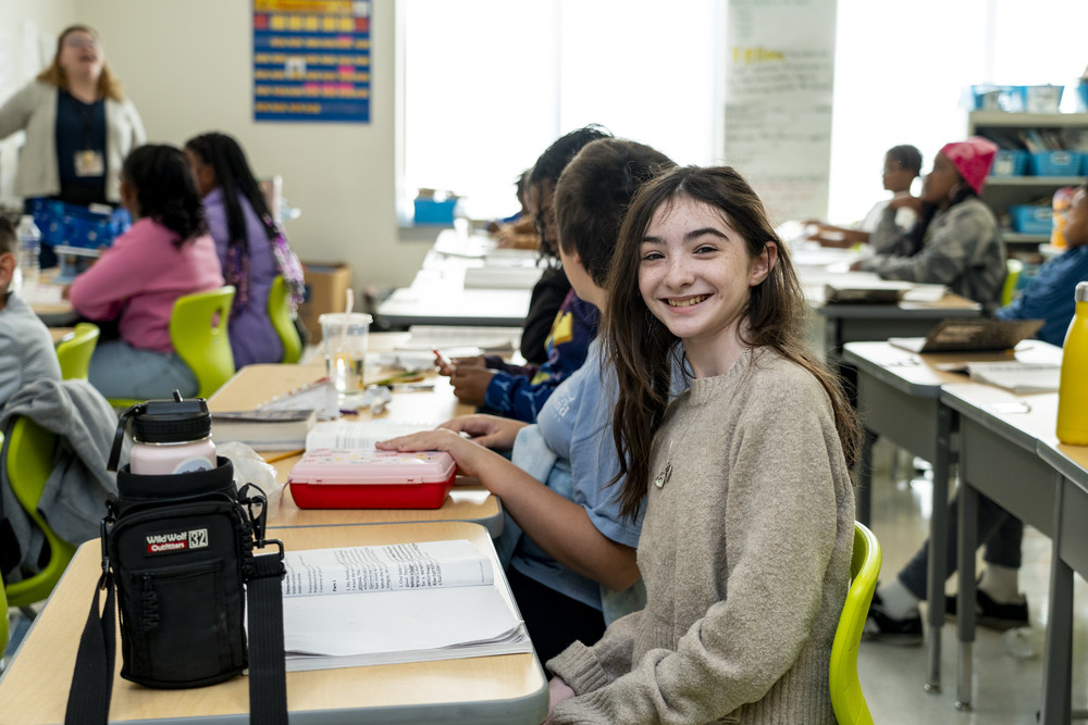 Medfield Heights student smiles at the camera while in class