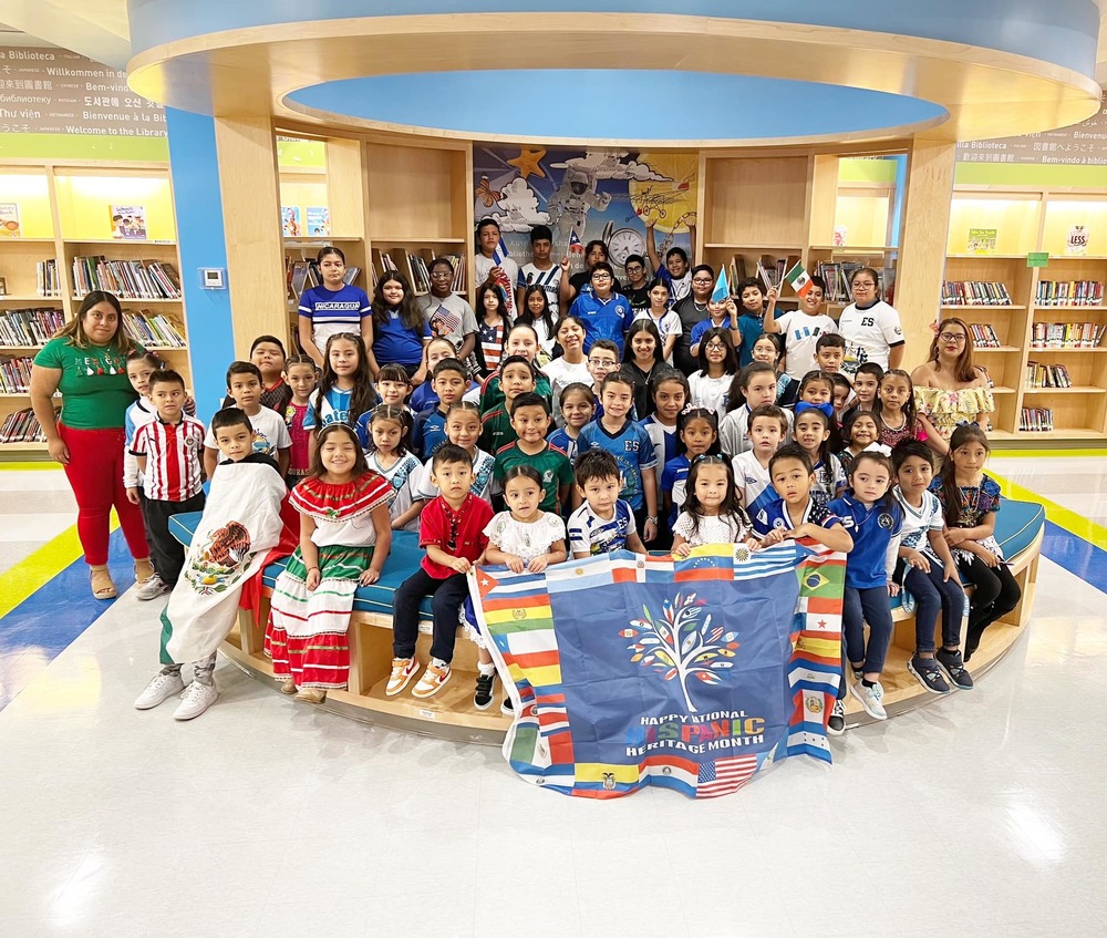 Students and staff posing in a photo at a library