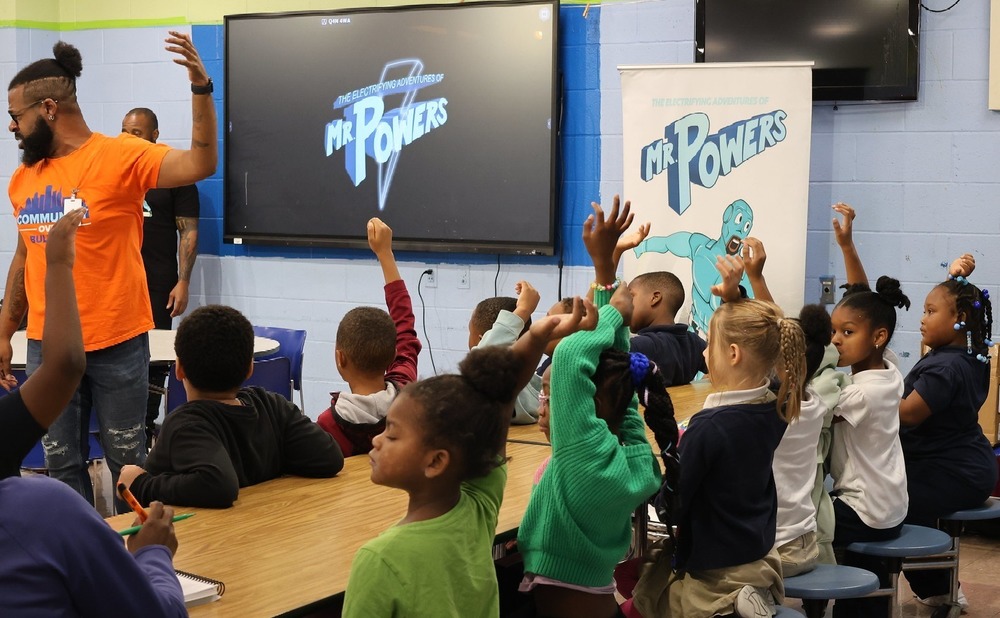 George Washington students listen as McGill does a Mr. Powers read along in the school's cafeteria. 