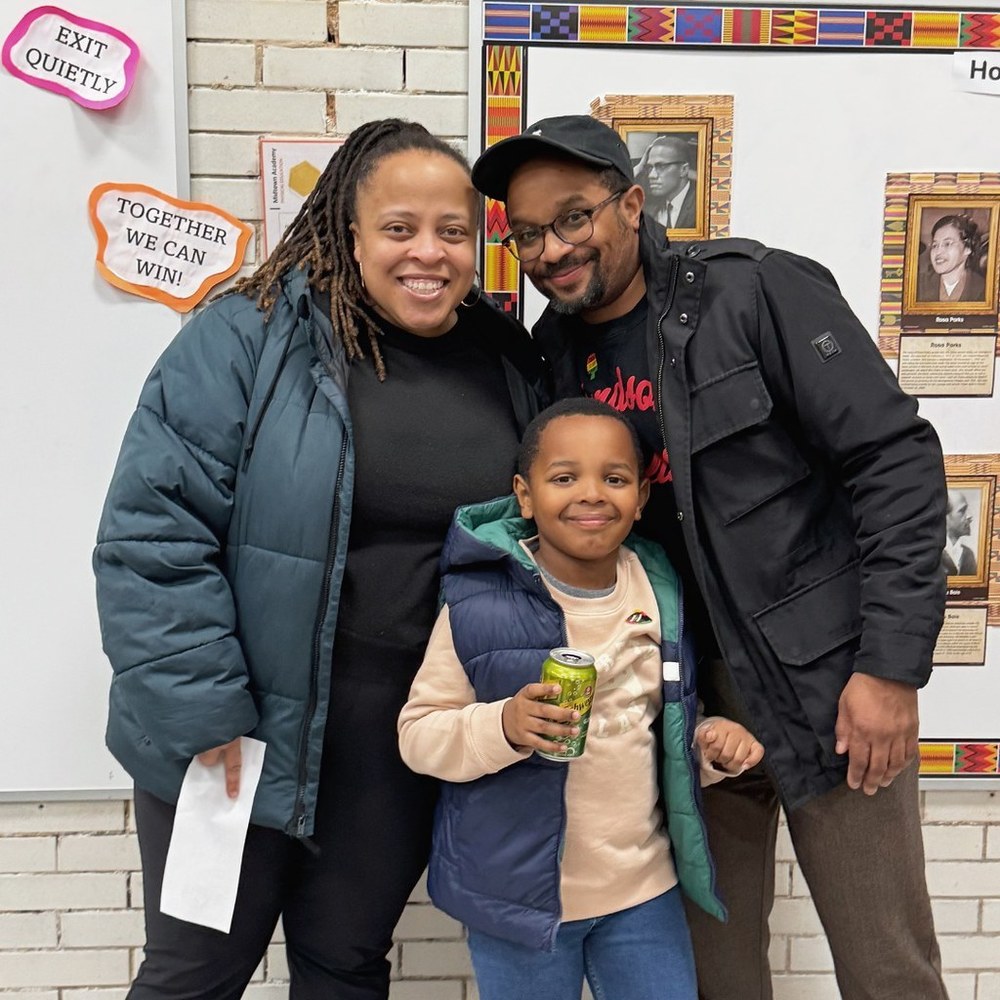 Family poses for a picture at a school.