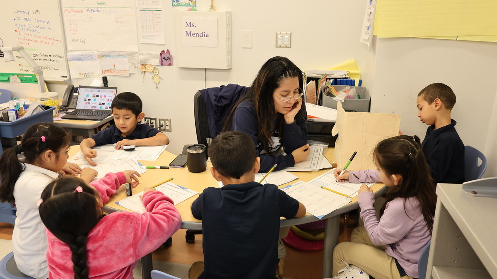 Small groups form in a bilingual english kindergarten class at John Rurah