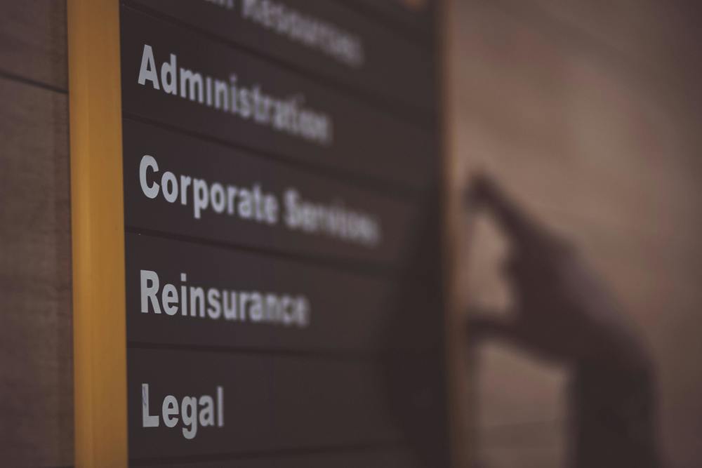 a sign with different department names like "legal" and "administration"