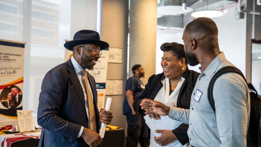 MWBE symposium attendees chat over a table