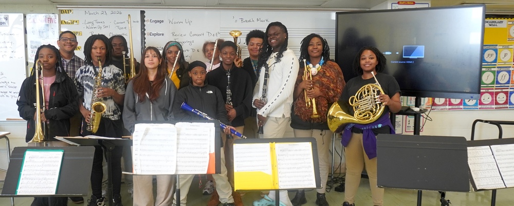 Reginald F. Lewis band members pose with their teacher Mr. Robinson in their classroom