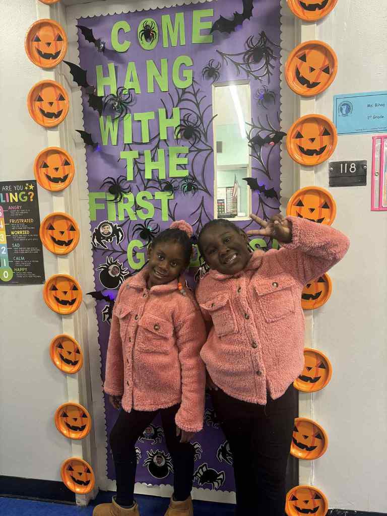 2 first graders wearing matching shirts.