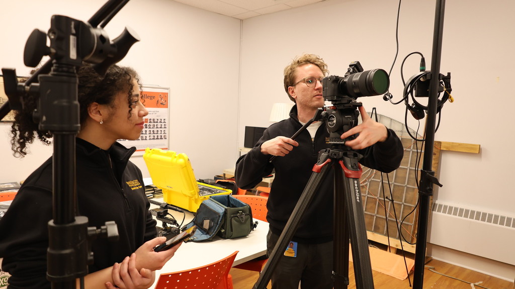 Staff and student filming a movie