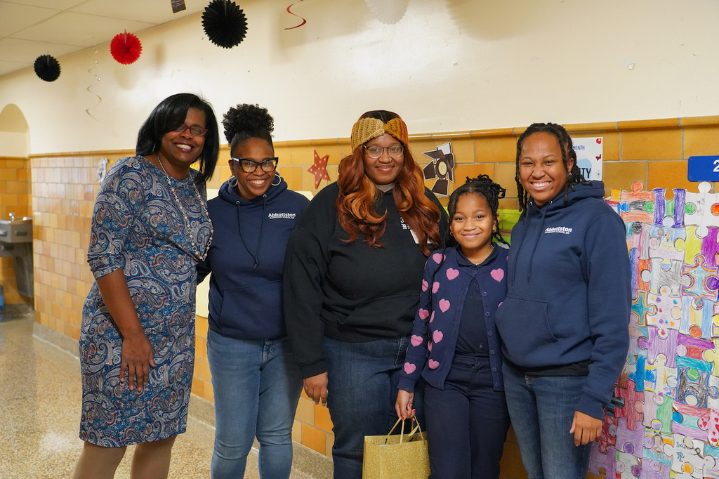 Rosa poses for a picture with teachers and family at Abbottston Elementary