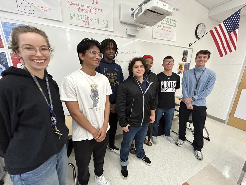Our AP course connoisseurs line up for a photo against a classroom whiteboard (from left to right): Jennifer DeJong, Sudarshan, Jordan, Oscar, Audrey, Jevons Liu, Peder Delia 