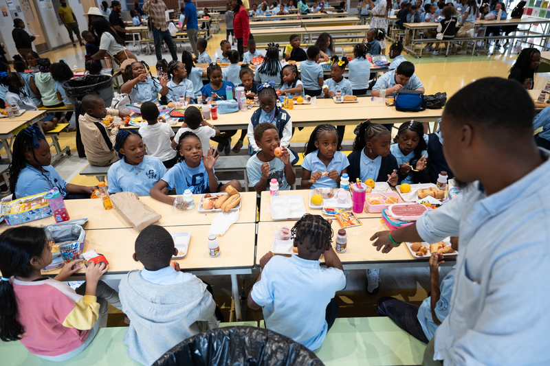 Students eat lunch in the cafeteria on the first day of school.