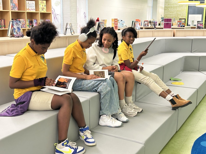 KIPP students sit and review the literary magazine they created 
