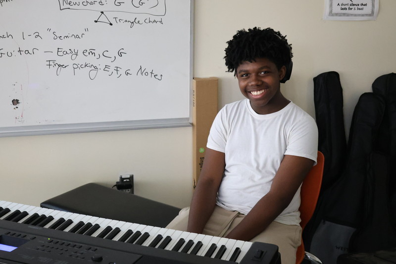 Jonathan was one of the YouthWorks students at the camp, poses by his piano. 