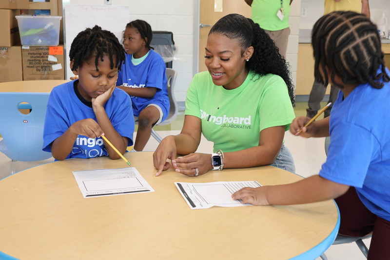Springboard staff assists students with a writing exercise. 