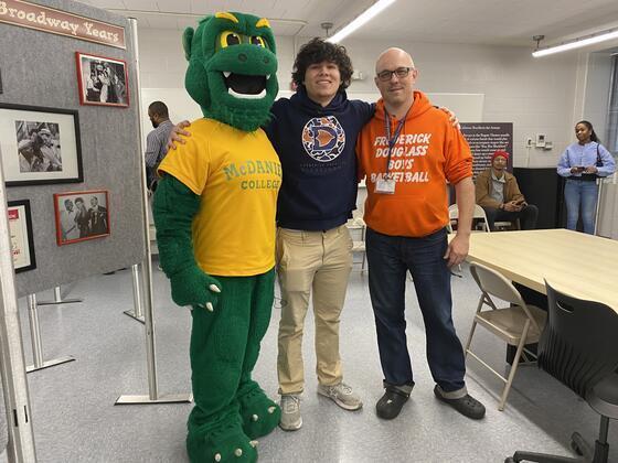 Malver poses with McDaniel mascot and his teacher at Douglass