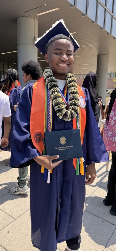 Tywan Wright pictured in his graduation ceremony cap and gown .