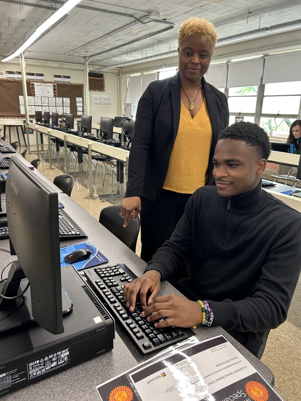 Genesis Cruikshank and Ms. Moore work in the computer lab