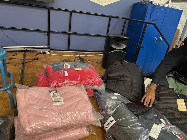 School Police hand out coats and pose for photos at Midtown Academy 