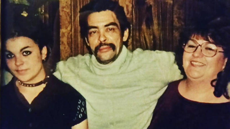 Tiffany and her parents pose for a photo. 