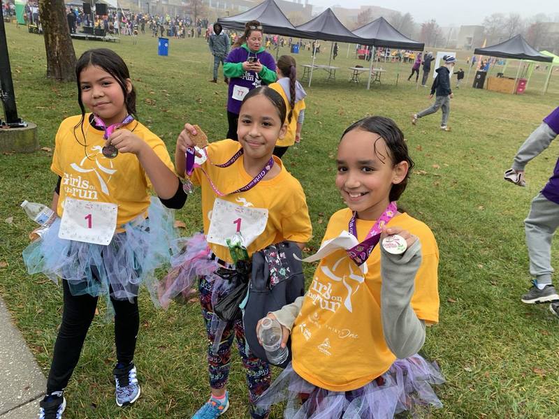 Schoolgirls run as part of the "Girls on the run" program at Armistead Gardens