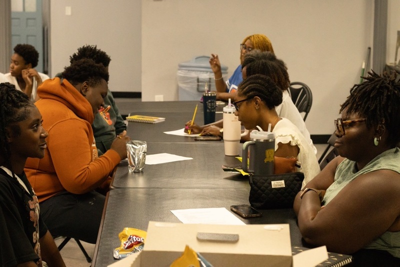 Mentor facilitates a learning exercise in a classroom.