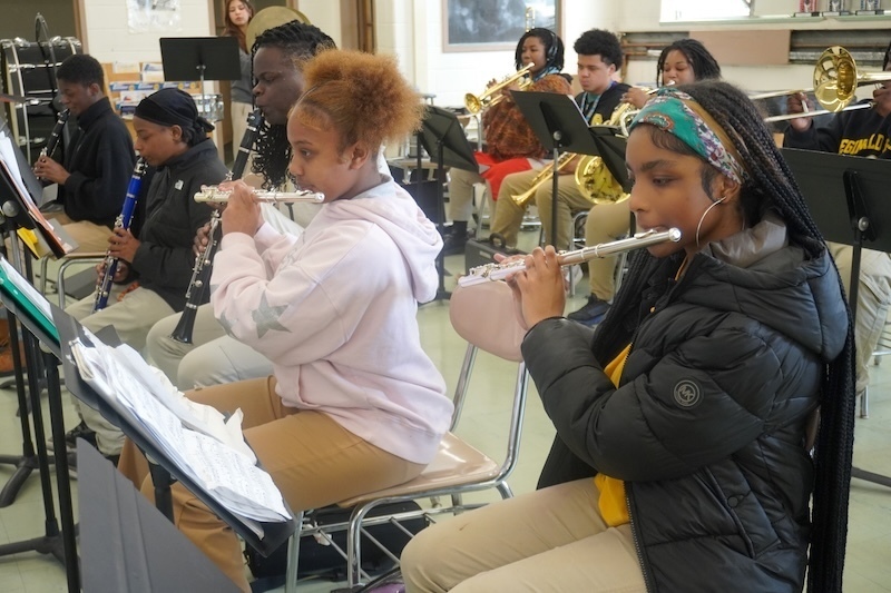Students in band class playing instruments