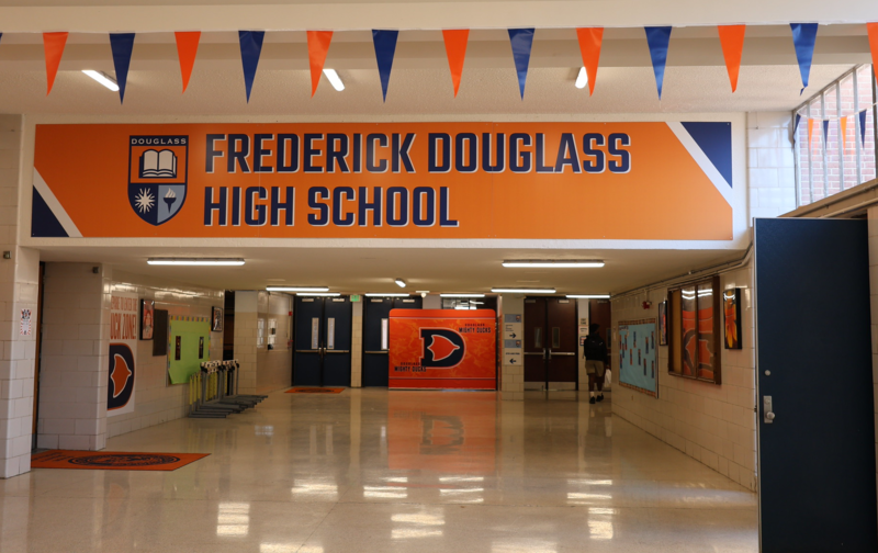Banner reading "Frederick Douglass High School' hangs in the main hallway of the school building.