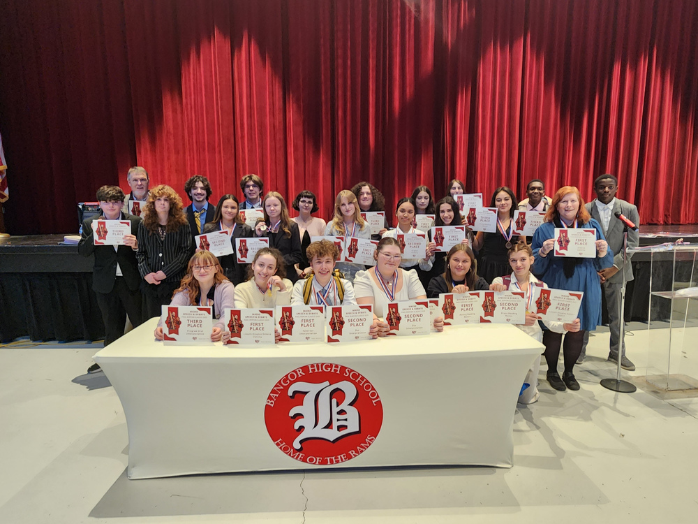 This weekend, the Bangor High School Speech and Debate teams hosted the Paul Bunyan Classic Speech and Debate Tournament. Students pose with their certificates and metals.