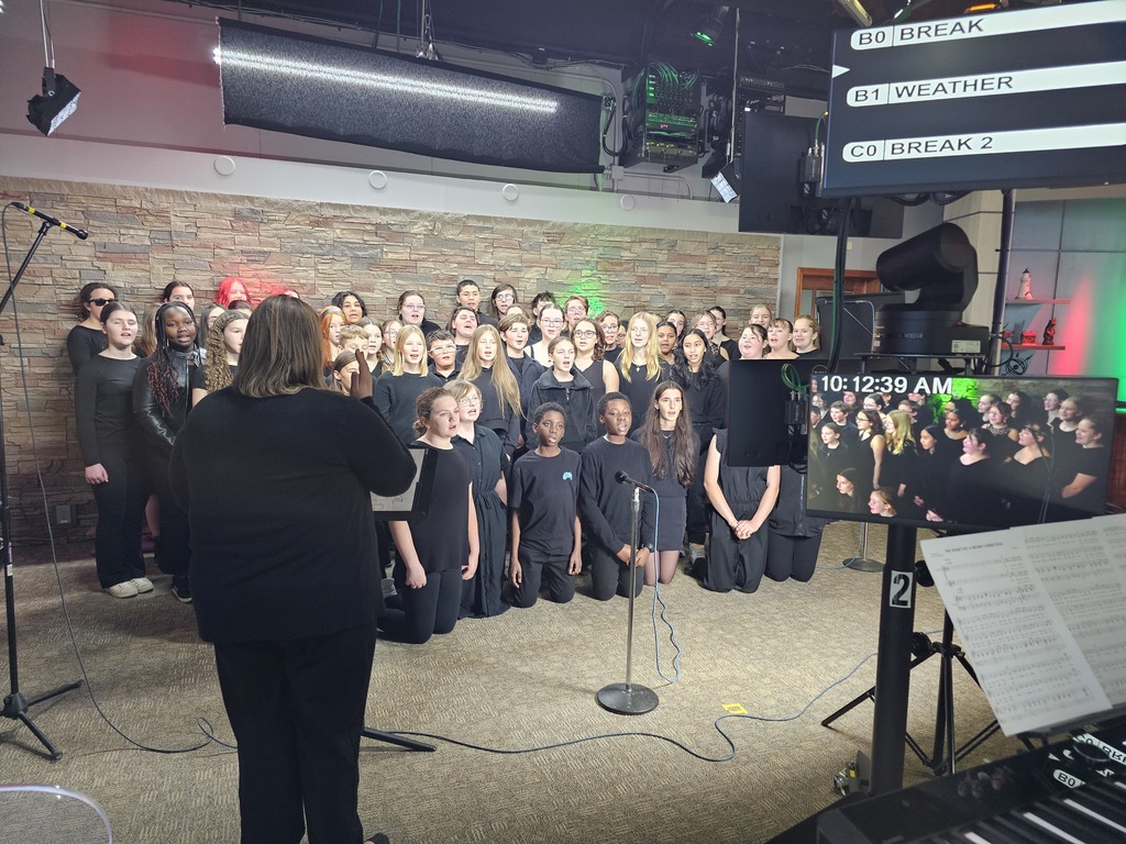 Mrs. Cousins directing the middle school chorus