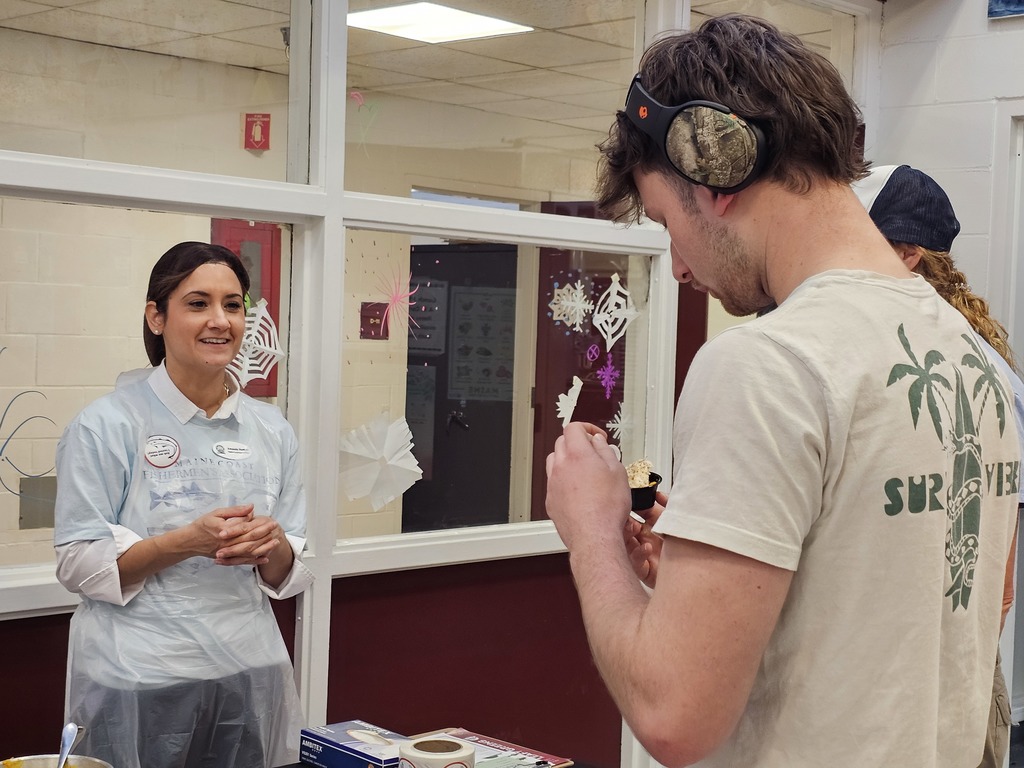 Amanda Junkins speaking with a BHS student about the nutritional value of the fish available at lunch.