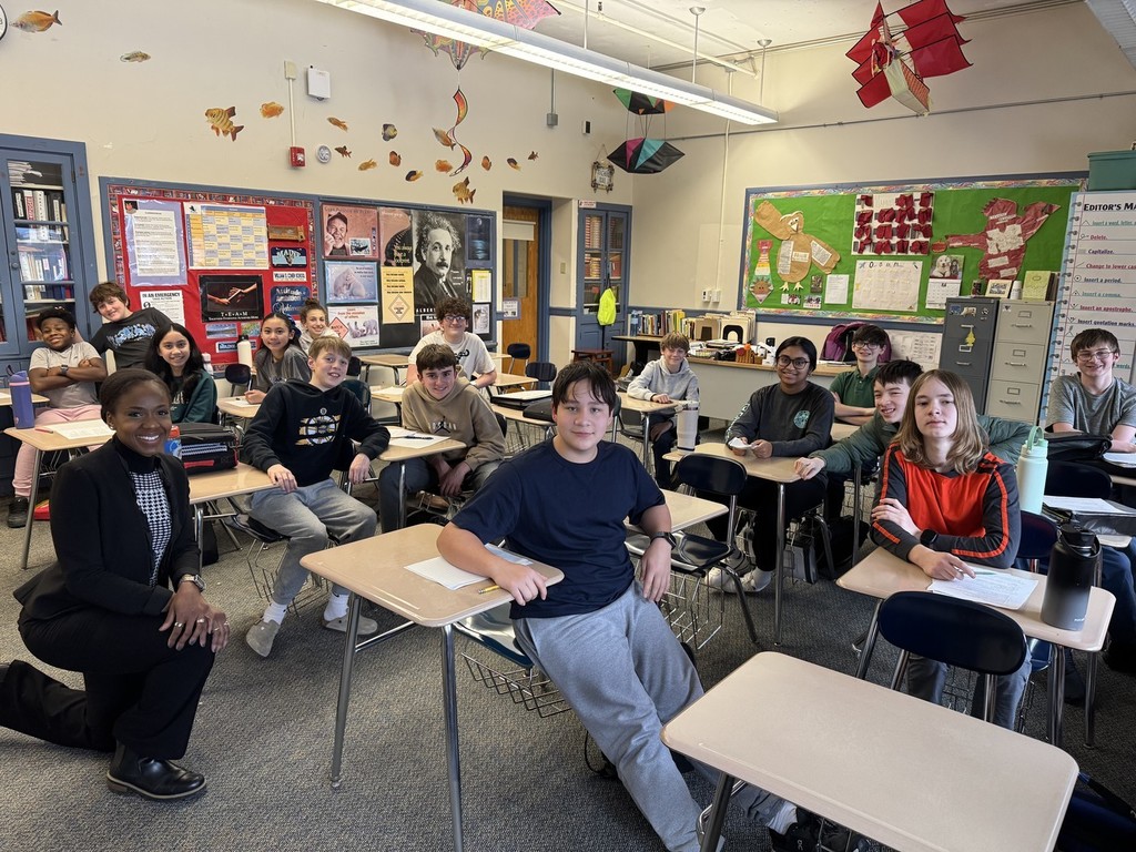 Students in Mrs. Martin’s accelerated English Language Arts class recently welcomed guest speaker Mrs. Shelly Okere, a prosecuting attorney and parent, as the culminating experience of their study of The Outsiders by S. E. Hinton. Prior to her visit, students wrote argumentative essays taking on the role of either a defense or prosecuting attorney, applying legal reasoning to the novel’s central conflicts and characters.  Mrs. Okere spoke with students about her work in juvenile law, sharing real-world insights into how cases involving young people are approached within the legal system. She emphasized the importance of compassion, fairness, and rehabilitation, helping students make meaningful  connections between literature, writing, and real-life decision-making. The visit provided an engaging and impactful conclusion to the unit. Thank you to Mrs. Okere for sharing her time and expertise with our students!